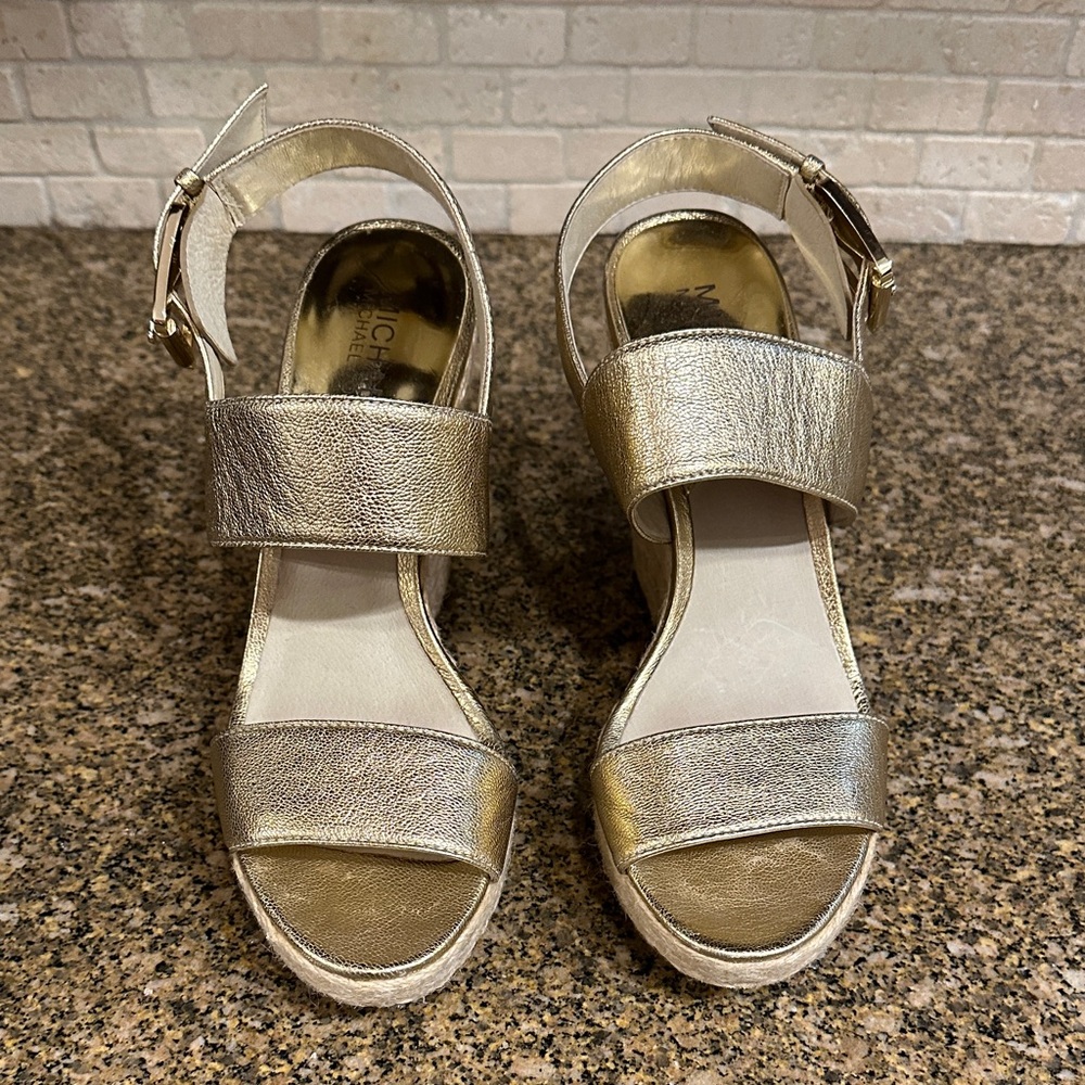 The MICHAEL Michael Kors Posey Gold Metallic Leather Wedge Sandals.  Size 7
